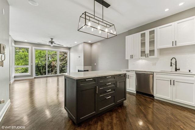 2259 W Wabansia Ave Unit 309, Chicago, IL 60647 - kitchen with dishwasher, a sink, white cabinetry, dark wood-style floors, and backsplash