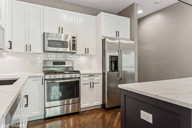 2259 W Wabansia Ave Unit 309, Chicago, IL 60647 - kitchen with appliances with stainless steel finishes, light stone countertops, dark wood-type flooring, tasteful backsplash, and recessed lighting