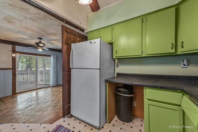 kitchen featuring dark countertops, ceiling fan, and white appliances