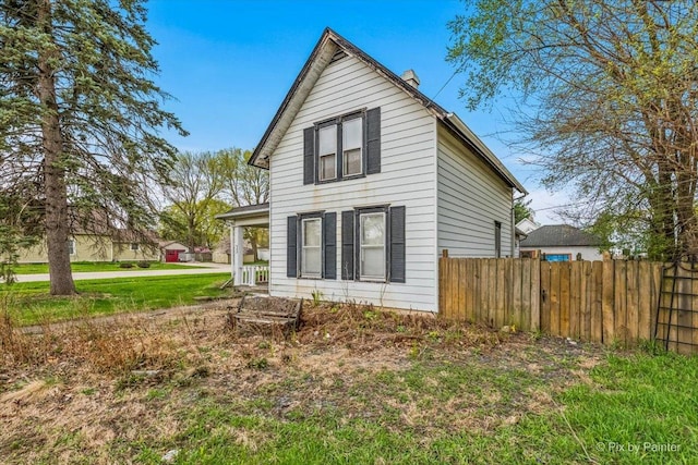 view of side of property featuring fence
