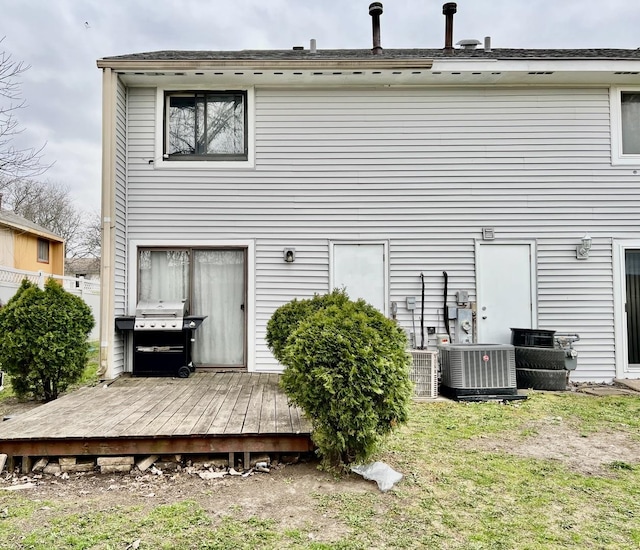 back of house featuring central AC unit and a deck
