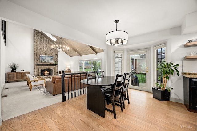 5930 Hillcrest Ct, Downers Grove, IL 60516 - dining area featuring a brick fireplace, a notable chandelier, and a wealth of natural light