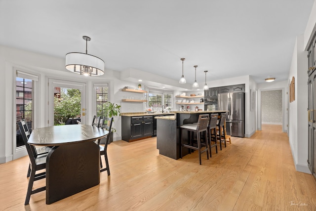 5930 Hillcrest Ct, Downers Grove, IL 60516 - kitchen with a kitchen breakfast bar, a center island, open shelves, freestanding refrigerator, and light wood finished floors