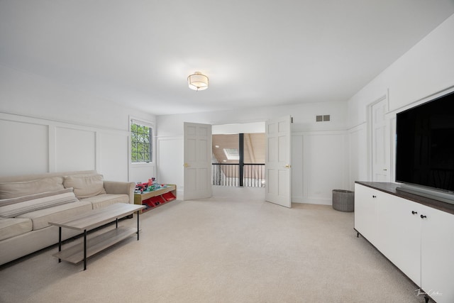 5930 Hillcrest Ct, Downers Grove, IL 60516 - living area with light colored carpet, a decorative wall, visible vents, and a wainscoted wall