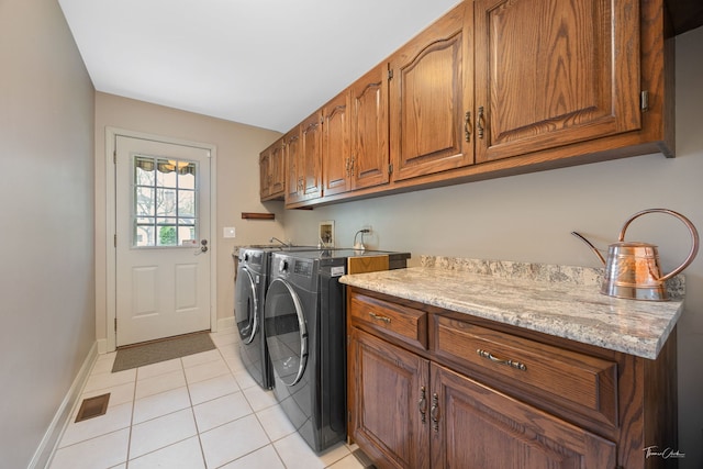 5930 Hillcrest Ct, Downers Grove, IL 60516 - washroom featuring visible vents, baseboards, washer and clothes dryer, cabinet space, and light tile patterned floors