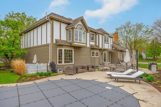 5930 Hillcrest Ct, Downers Grove, IL 60516 - rear view of house with fence, board and batten siding, a fenced in pool, an outdoor living space, and a patio area