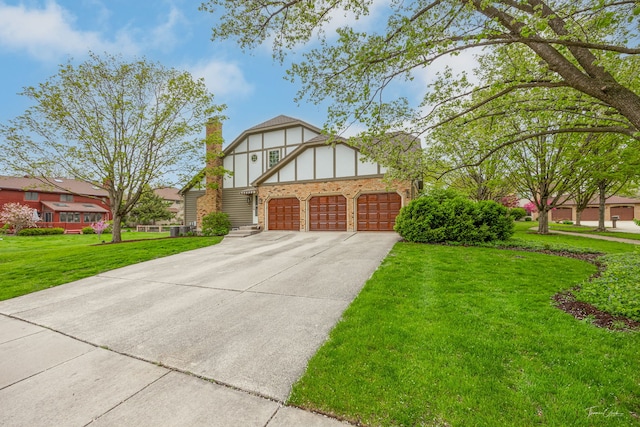5930 Hillcrest Ct, Downers Grove, IL 60516 - tudor-style house with a chimney, a front yard, brick siding, concrete driveway, and an attached garage