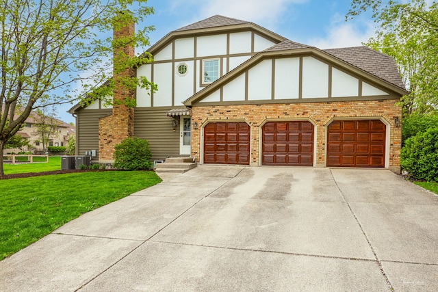 5930 Hillcrest Ct, Downers Grove, IL 60516 - tudor-style house with a garage, driveway, a front lawn, and brick siding