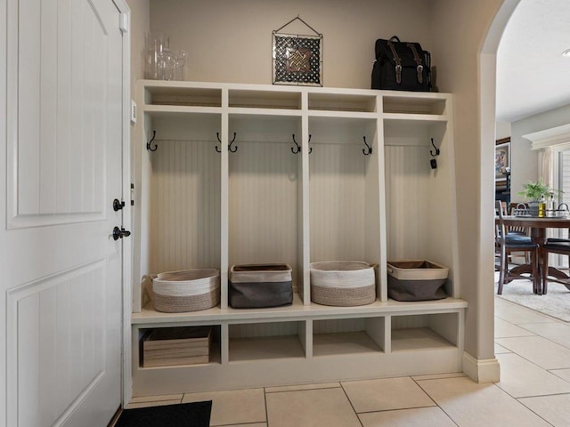 mudroom featuring tile patterned floors and arched walkways