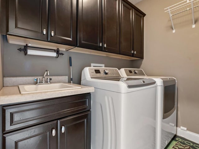 laundry room with a sink, cabinet space, and washing machine and clothes dryer