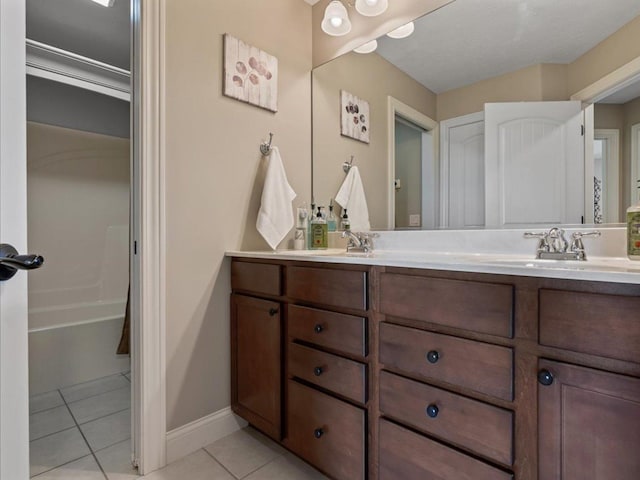 bathroom with double vanity, tile patterned floors, and a sink