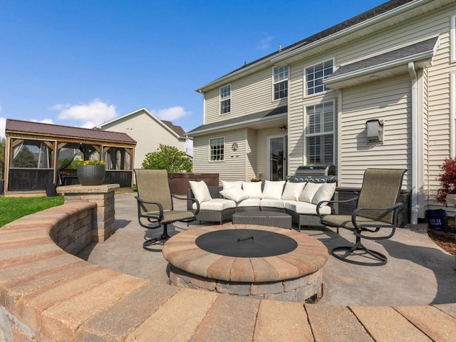 view of patio / terrace with a gazebo and an outdoor living space with a fire pit
