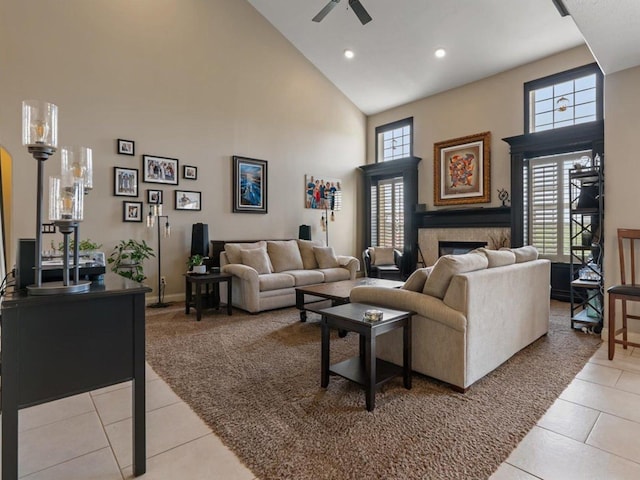 living room with light tile patterned floors, high vaulted ceiling, light carpet, and a ceiling fan