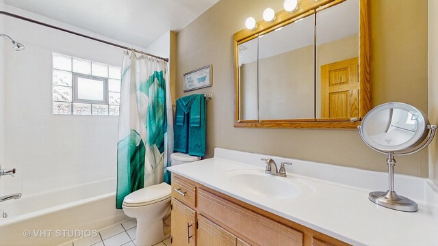full bath with tile patterned flooring, shower / tub combo with curtain, toilet, and vanity