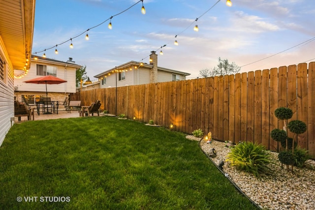 view of yard with a fenced backyard and a patio