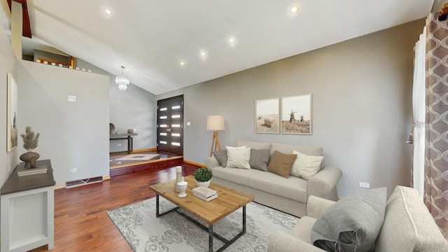 living area with visible vents, vaulted ceiling, wood finished floors, baseboards, and recessed lighting