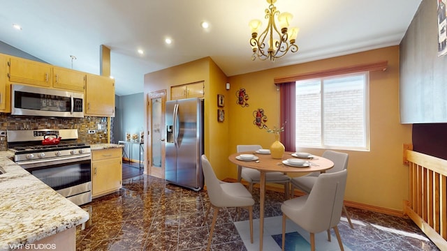 kitchen with a notable chandelier, appliances with stainless steel finishes, marble finish floor, baseboards, and decorative backsplash