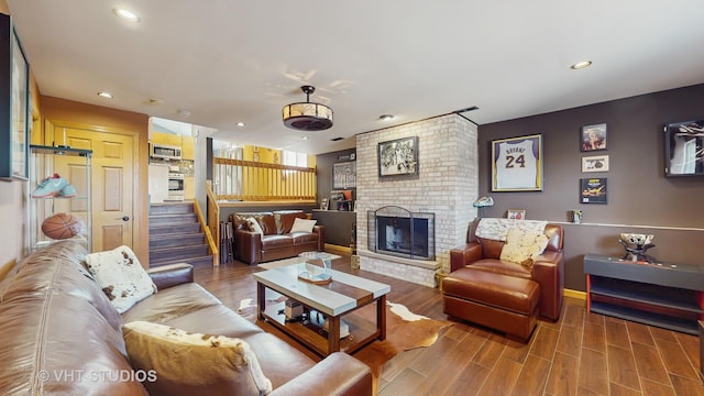 living area featuring recessed lighting, baseboards, stairway, and a fireplace