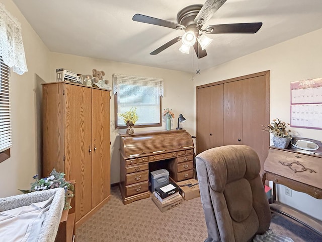 home office featuring light colored carpet and ceiling fan