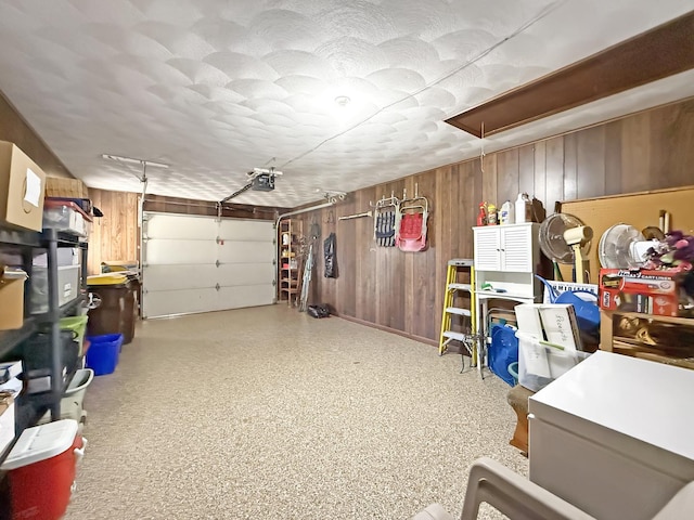 garage with wooden walls and a garage door opener