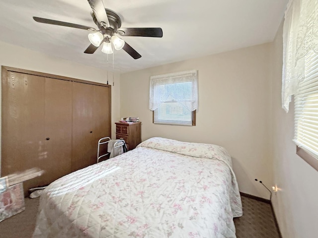 carpeted bedroom with a closet, baseboards, and ceiling fan