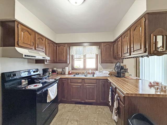 kitchen featuring light countertops, under cabinet range hood, black electric range oven, and a sink