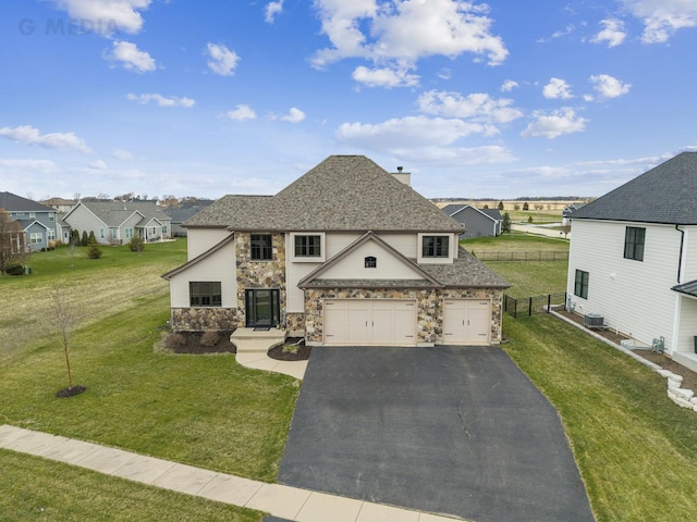 view of front of home with driveway, stone siding, fence, roof with shingles, and a residential view