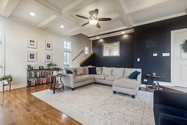 living area featuring beamed ceiling, wood finished floors, ceiling fan, and coffered ceiling