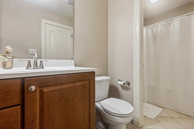 bathroom with vanity, toilet, and tile patterned flooring