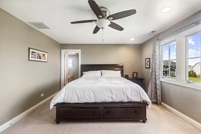 bedroom with baseboards, visible vents, and light carpet