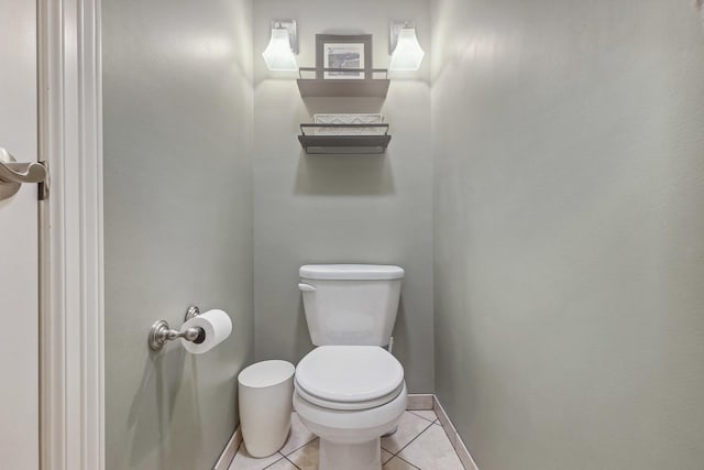 bathroom with baseboards, tile patterned flooring, and toilet