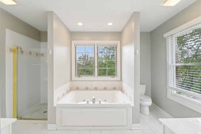 bathroom featuring a stall shower, toilet, a whirlpool tub, vanity, and tile patterned flooring