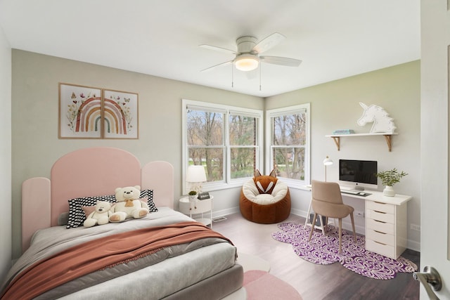 bedroom featuring a ceiling fan, wood finished floors, and baseboards