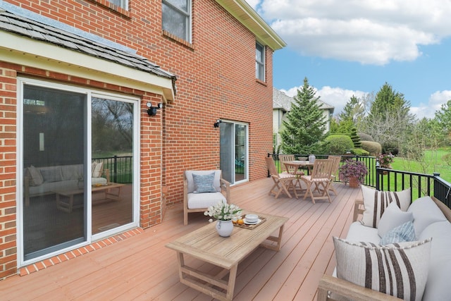 wooden deck featuring outdoor lounge area and outdoor dining space