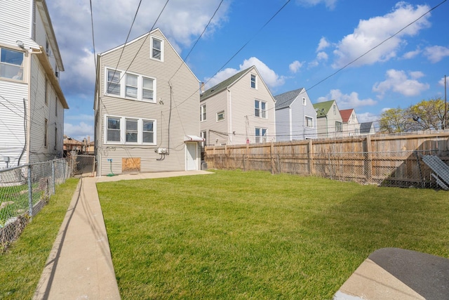 2147 N Latrobe Ave, Chicago, IL 60639 - back of house featuring a fenced backyard, a yard, a residential view, and a patio