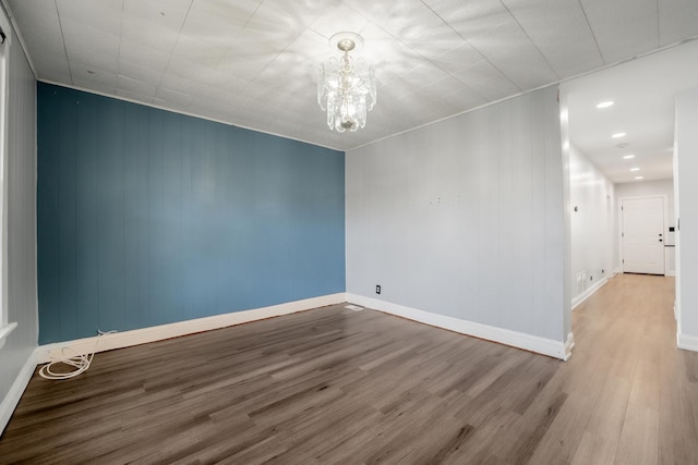 2147 N Latrobe Ave, Chicago, IL 60639 - empty room with recessed lighting, wood finished floors, baseboards, and a notable chandelier