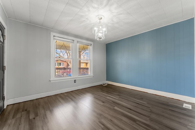2147 N Latrobe Ave, Chicago, IL 60639 - unfurnished room with a chandelier, wood finished floors, and baseboards