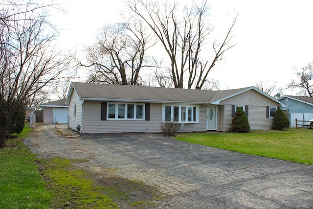 single story home featuring a front lawn, aphalt driveway, and roof with shingles