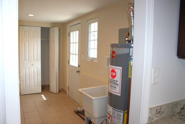 utilities with water heater and a sink