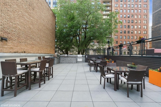 view of patio with area for grilling and outdoor dining space