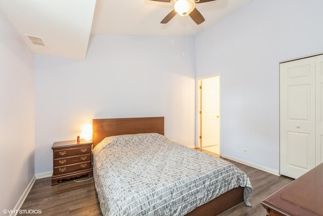 bedroom with baseboards, visible vents, a closet, and dark wood finished floors