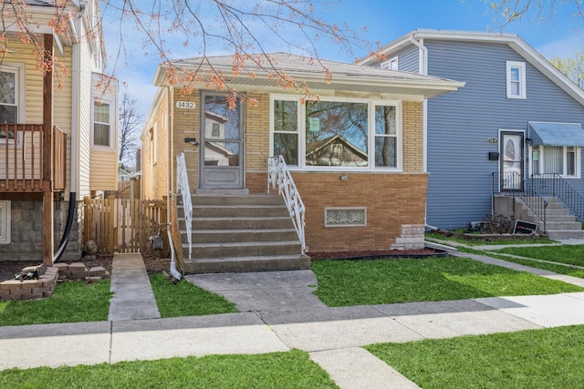 1432 Marengo Ave, Forest Park, IL 60130 - view of front facade with fence, a front lawn, and brick siding