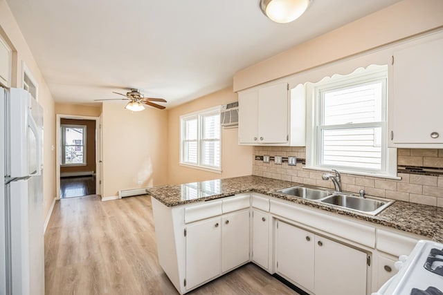 1432 Marengo Ave, Forest Park, IL 60130 - kitchen with a peninsula, a sink, tasteful backsplash, freestanding refrigerator, and range