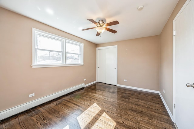 1432 Marengo Ave, Forest Park, IL 60130 - unfurnished bedroom featuring a baseboard radiator, wood finished floors, a closet, and baseboards
