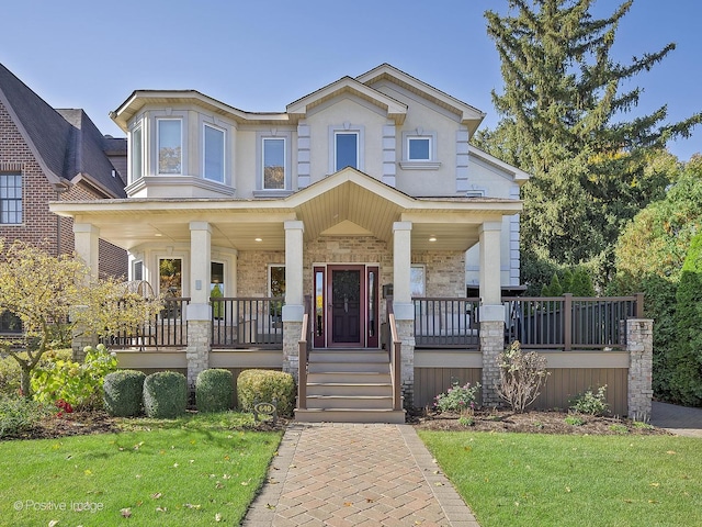 view of front of property featuring a porch, brick siding, and a front yard