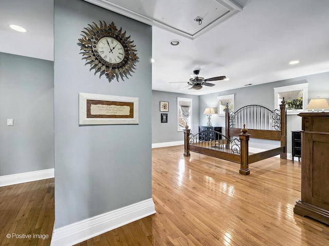 interior space with attic access, baseboards, light wood finished floors, and recessed lighting
