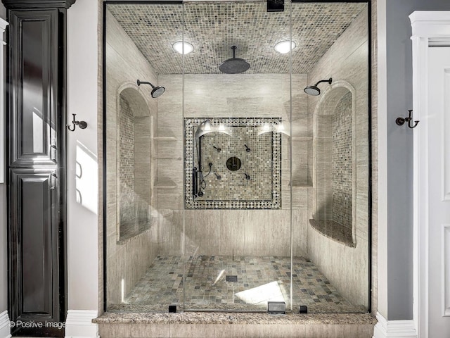 full bath with baseboards and a shower stall