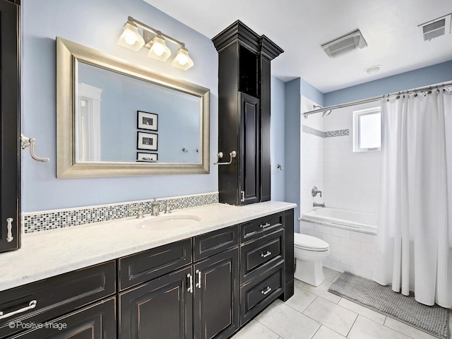 full bathroom with tiled shower / bath, visible vents, tile patterned flooring, and vanity