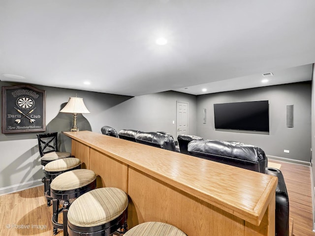 bar with light wood-style flooring, baseboards, and recessed lighting