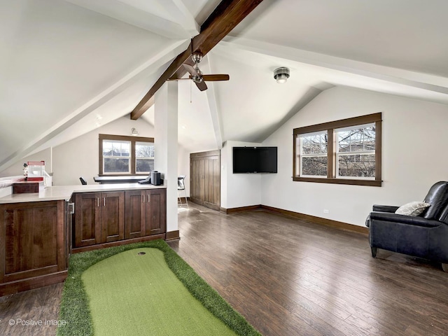 interior space featuring wood finished floors, vaulted ceiling with beams, baseboards, and a ceiling fan